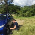 Matt-changing-the-tire,-somewhere-in-Jamaica