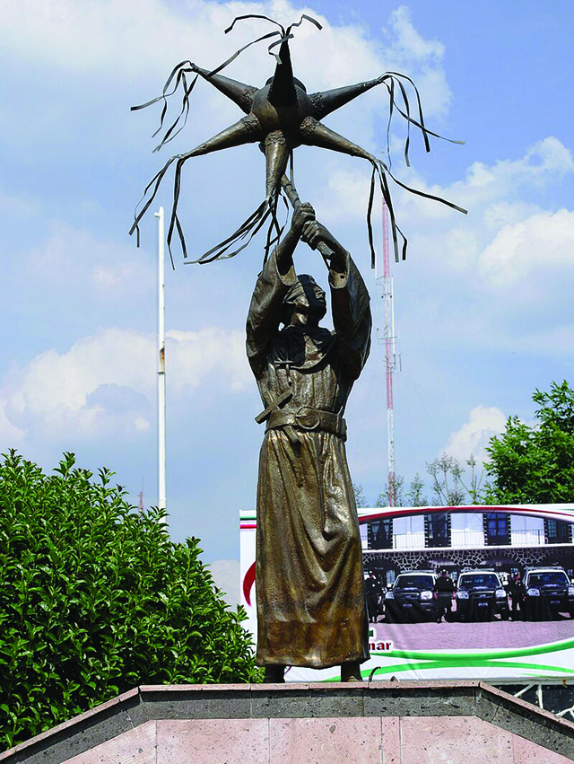 Statue-of-Franciscan-friar-hitting-a-piñata-in-Acolman-Mexico-State.-Source-Wikipedia